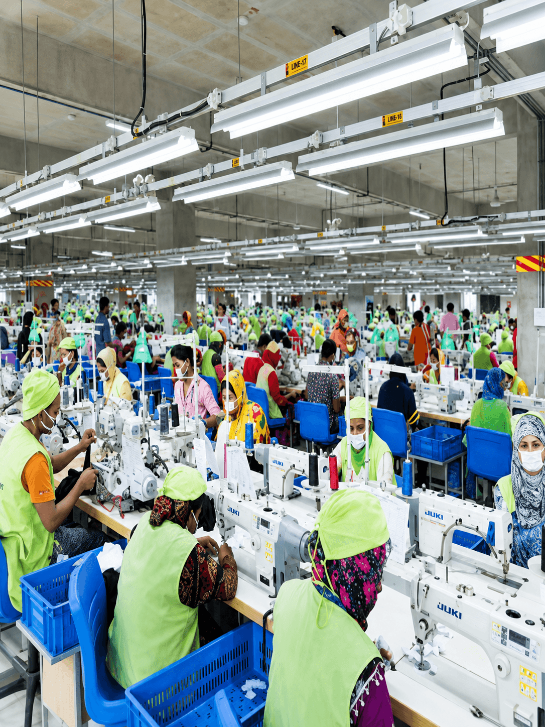 Overhead tube lighting above the sewing lines on the AKH Knitting & Dyeing production floor